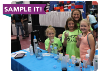 Kids sampling juice at the expo center.