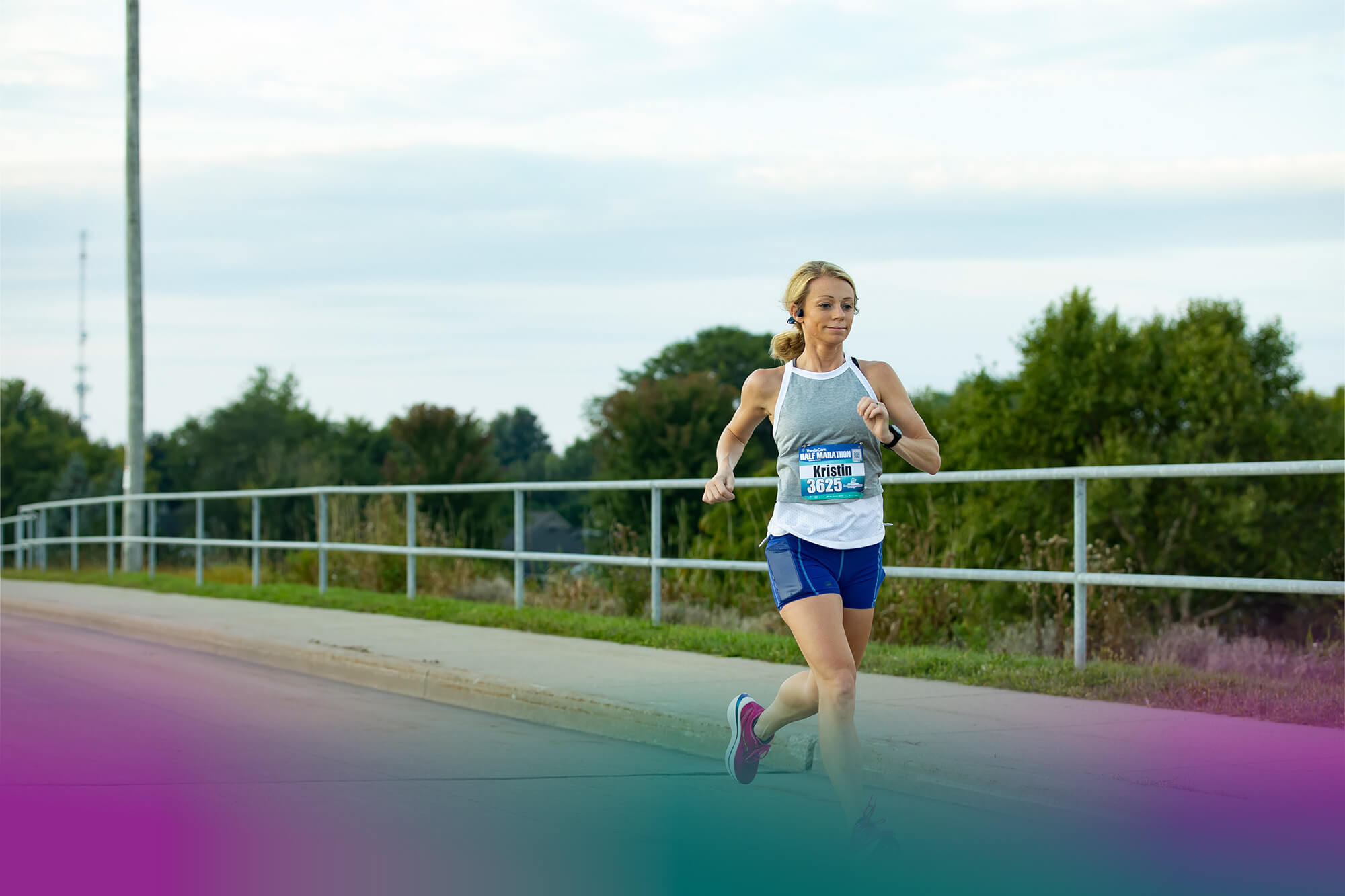 Fox Cities Marathon Female Runner on Road with Trees in Background