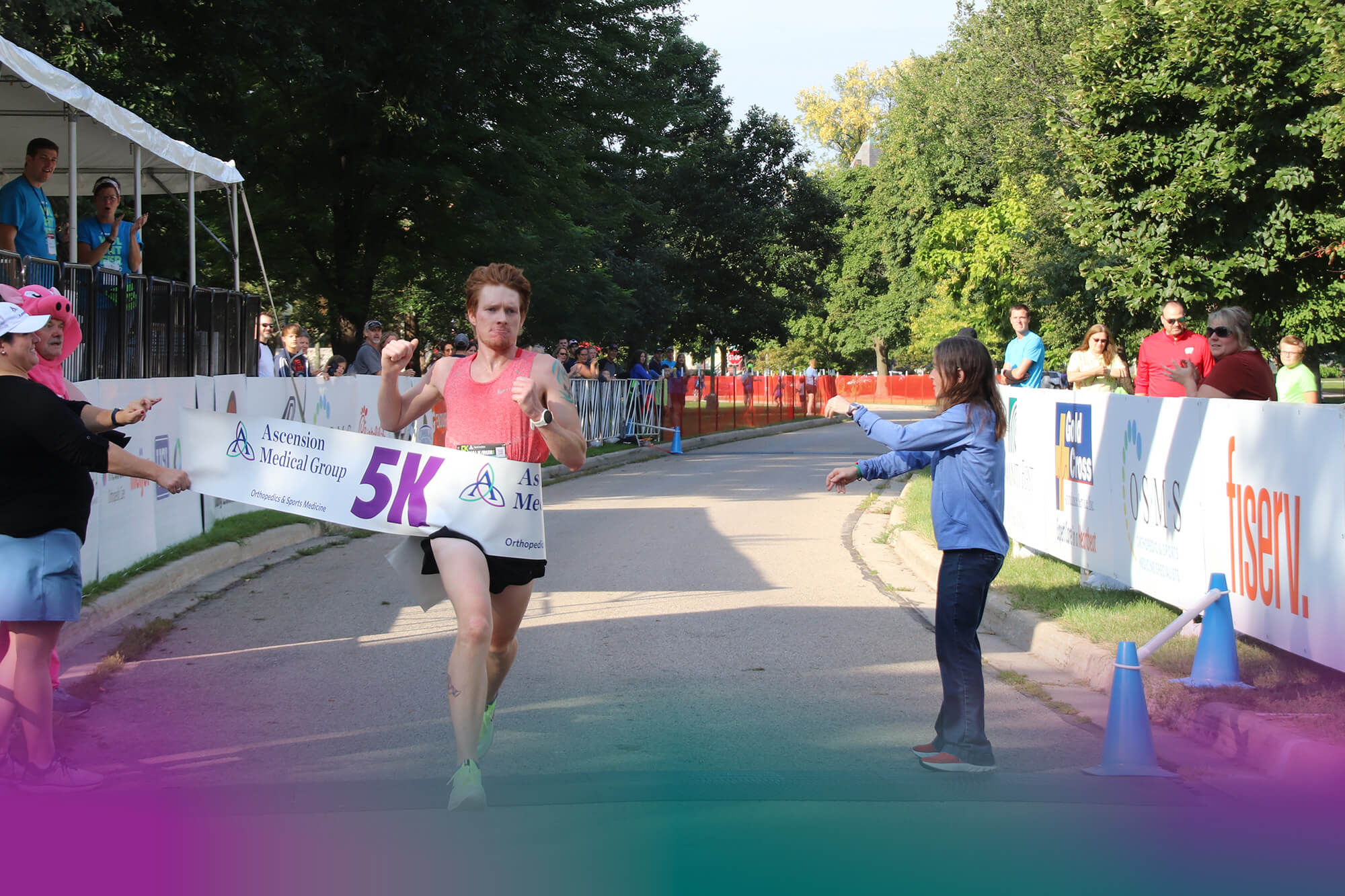 Fox Cities Marathon Man in Pink Tank Top Crossing Finish Line in 5K