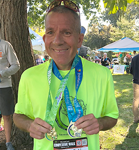 Kevin wearing medals from competitive walks.