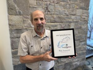Fox Cities Marathon Legacy Runner Club Mike Jovanovich holding certificate.