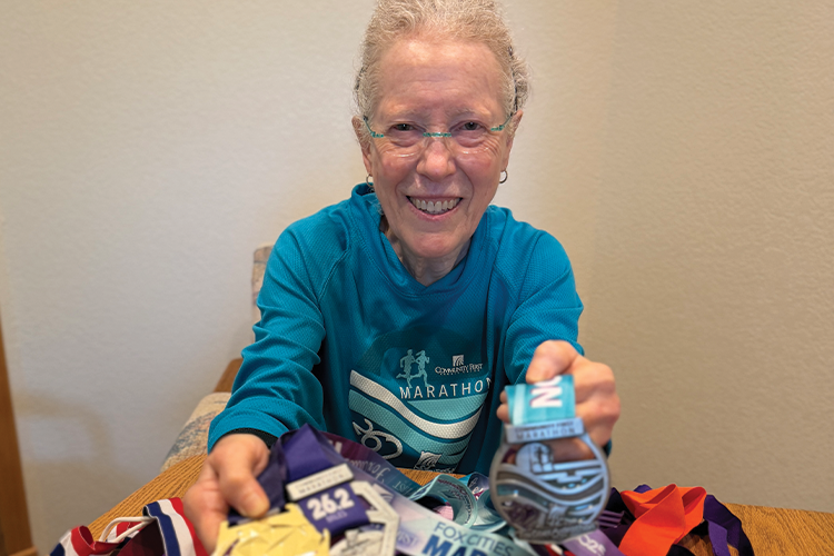 Fox Cities Marathon 35 Years Running Legacy Runner Dr. Anne Siegrist with medals.