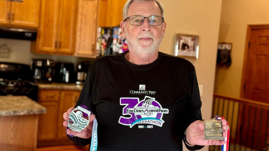 Fox Cities Marathon 35 Year Legacy Runner Fred Ulman with his medals.