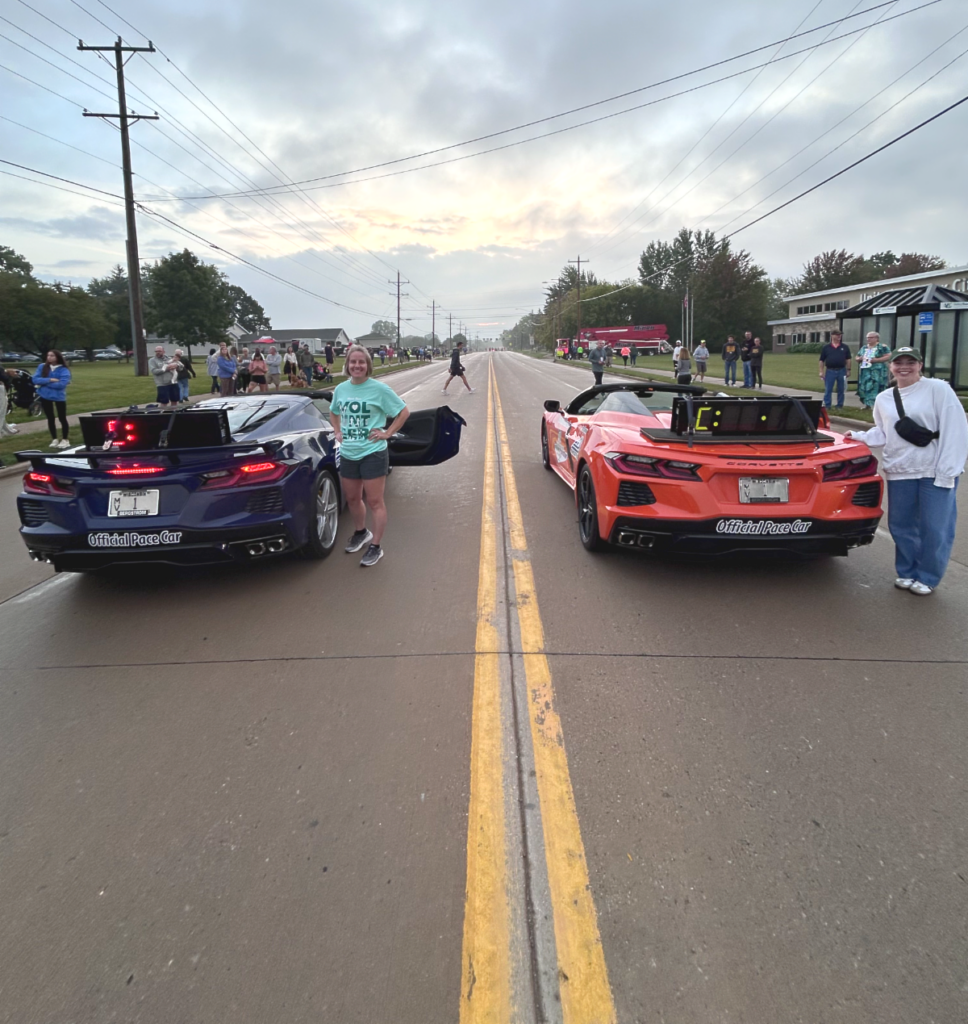 Fox Cities Marathon proud sponsor Bergstrom Automotive's pace cars, black and orange Corvettes leading the race.