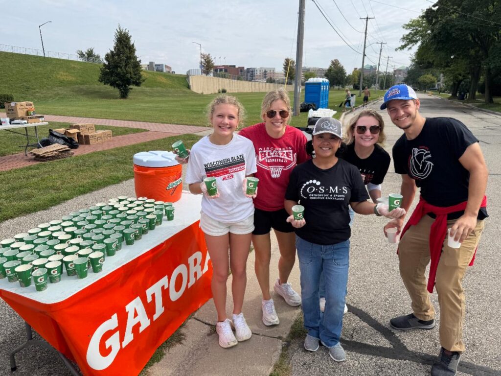Fox Cities Marathon Gatorade Endurance water station with volunteers.