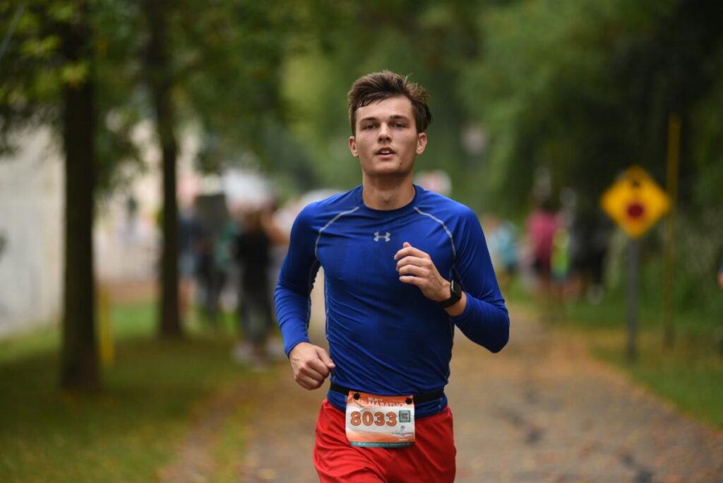 Fox Cities Marathon Relay Marathon runner in dark blue shirt.