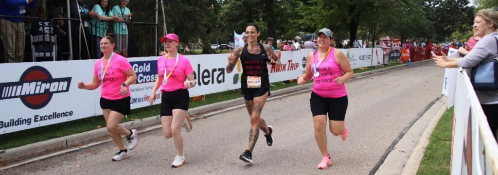 Fox Cities Marathon Relay Marathon runners in pink and black shirts.