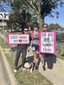 Fox Cities Marathon women cheering with signs.