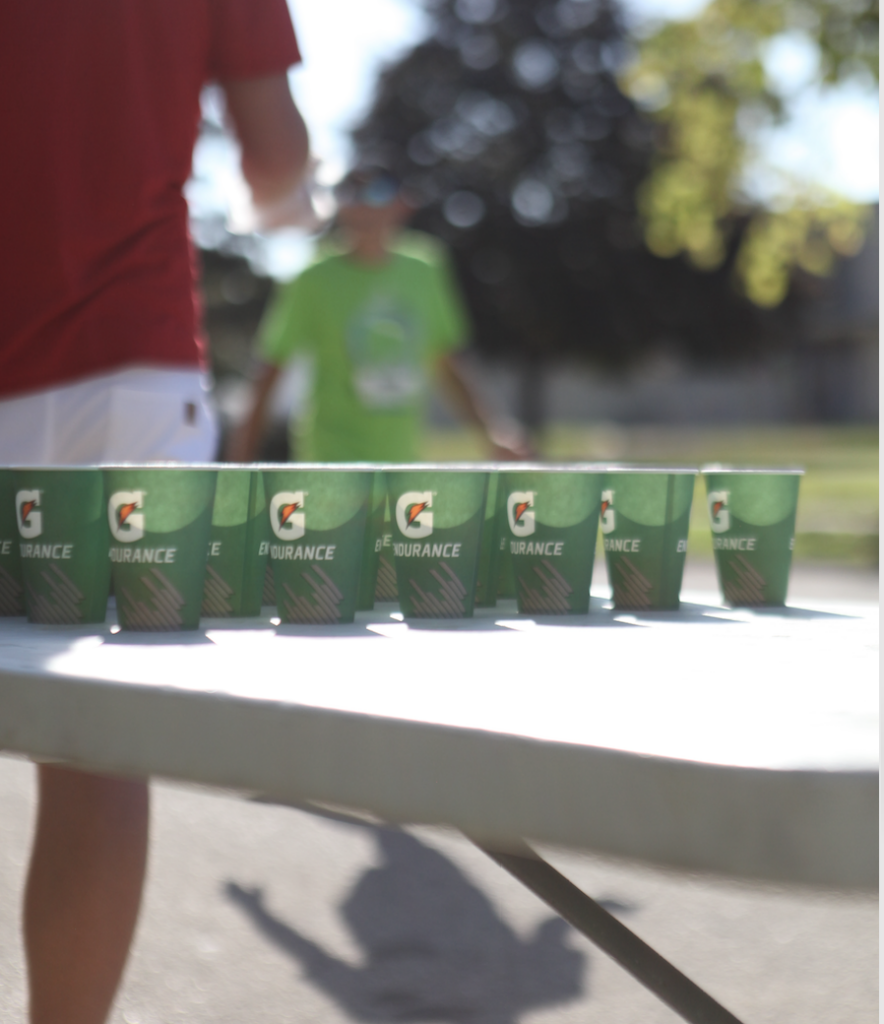 Fox Cities Marathon Gatorade water station, runners with a table and Gatorade cups.