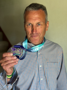 Fox Cities Marathon 35 Years Running Legacy Runner Gary Nettekoven with marathon medal.