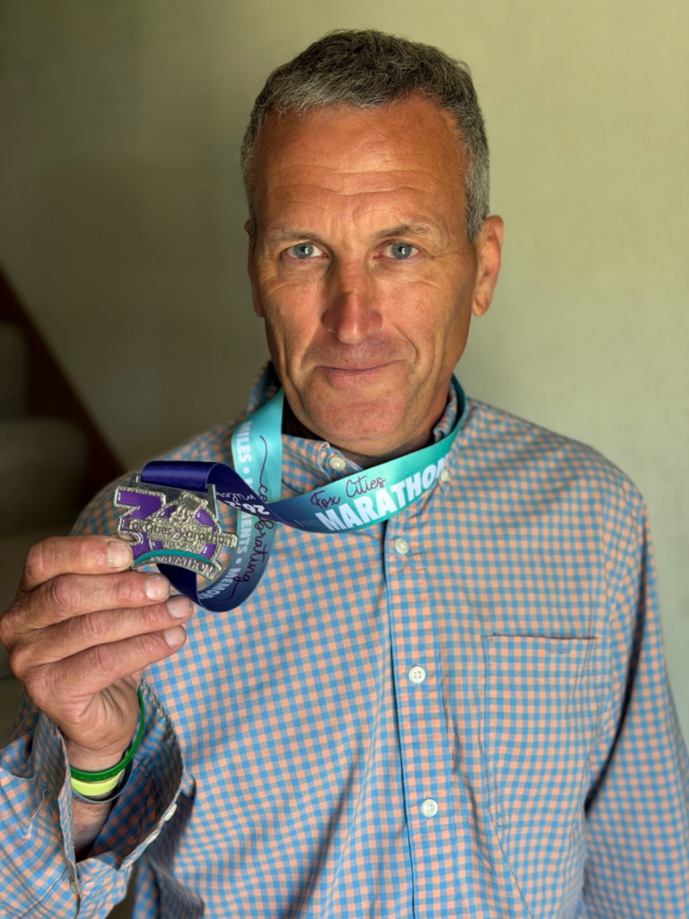 Fox Cities Marathon 35 Years Running Legacy Runner Gary Nettekoven with marathon medal.